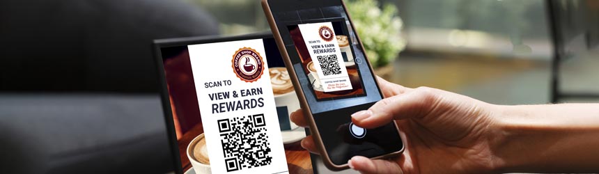 A person scans a QR code on a table sign with their smartphone to access the RewardPocket System and earn rewards at a coffee shop, seamlessly integrating business incentives into their daily routine.