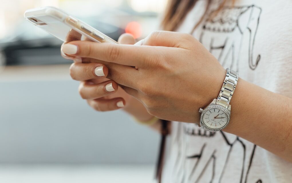 Woman holding mobile phone, using easy-to-use loyalty app